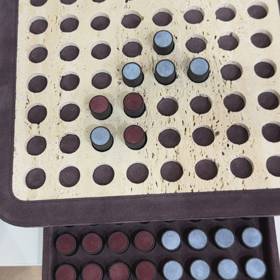 Giobagnara | Delos Othello Game Set Marble: Arabescato white or travertino leather-covered board with metal playing pieces and leather inserts | Game Room | 2Jour Concierge, your luxury lifestyle shop | luxury othello marble, Giobagnara Delos, marble game board, Italian designer game
