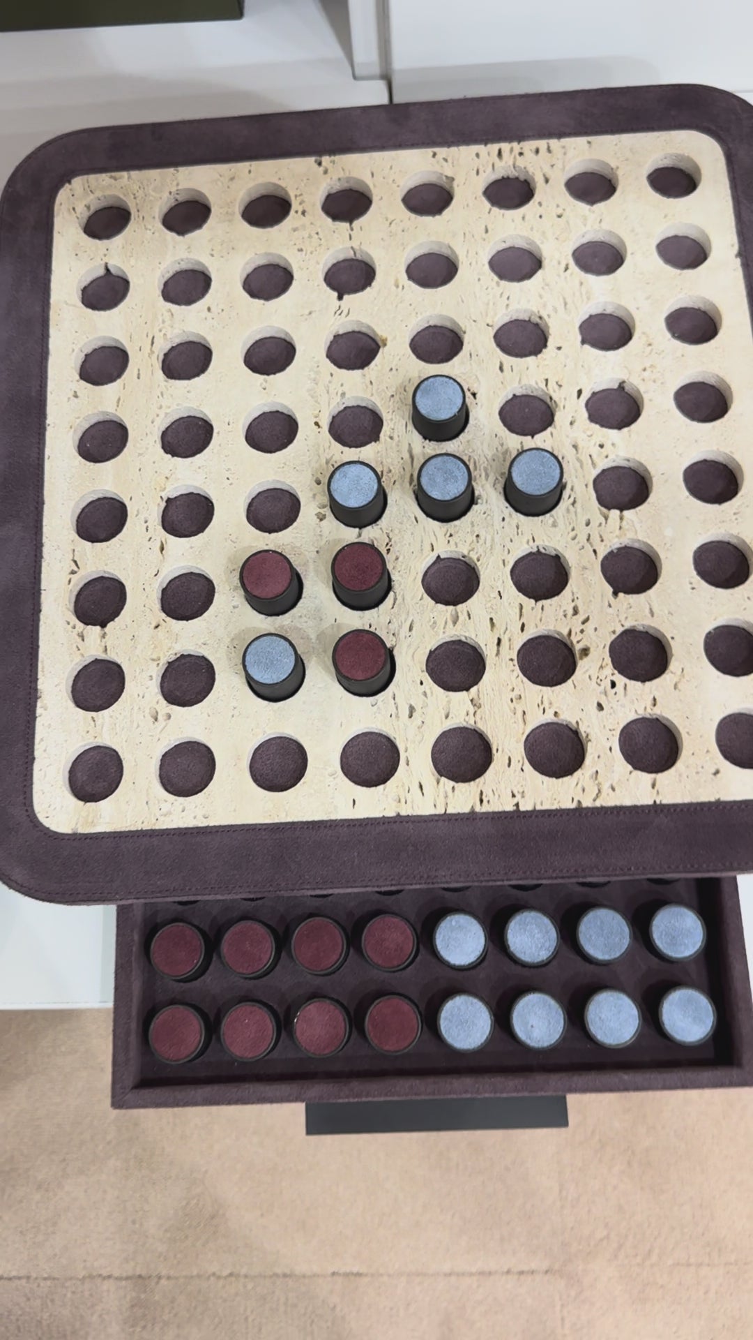 Giobagnara | Delos Othello Game Set Marble: Arabescato white or travertino leather-covered board with metal playing pieces and leather inserts | Game Room | 2Jour Concierge, your luxury lifestyle shop | luxury othello marble, Giobagnara Delos, marble game board, Italian designer game