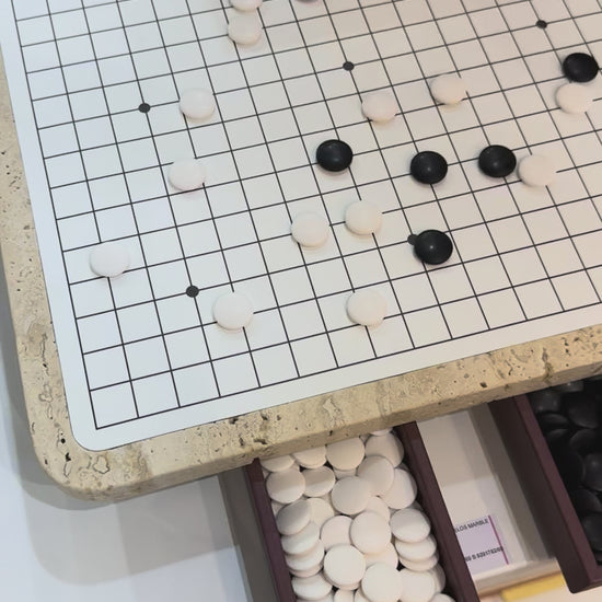 Giobagnara | Delos Go Game Set Marble: Arabescato white or travertino top with digital-printed leather playing field and Corian® beads | Game Room | 2Jour Concierge, your luxury lifestyle shop | luxury go game marble, Giobagnara Delos, marble game board, Italian designer game set