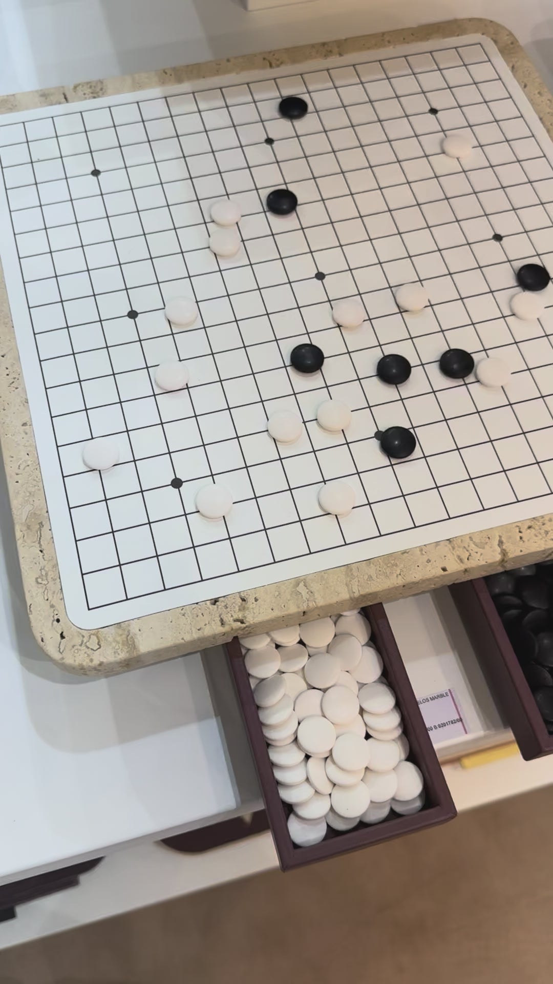 Giobagnara | Delos Go Game Set Marble: Arabescato white or travertino top with digital-printed leather playing field and Corian® beads | Game Room | 2Jour Concierge, your luxury lifestyle shop | luxury go game marble, Giobagnara Delos, marble game board, Italian designer game set