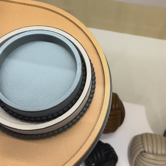 Giobagnara | Perla Round Trinket Box: Leather-covered round box with lid and metal ring of linked spheres | Decor | 2Jour Concierge, your luxury lifestyle shop | luxury trinket box, Giobagnara Perla, round leather box, Italian designer box, leather storage box