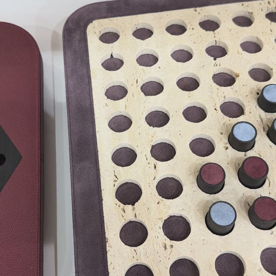 Giobagnara | Delos Othello Game Set Marble: Arabescato white or travertino leather-covered board with metal playing pieces and leather inserts | Game Room | 2Jour Concierge, your luxury lifestyle shop | luxury othello marble, Giobagnara Delos, marble game board, Italian designer game