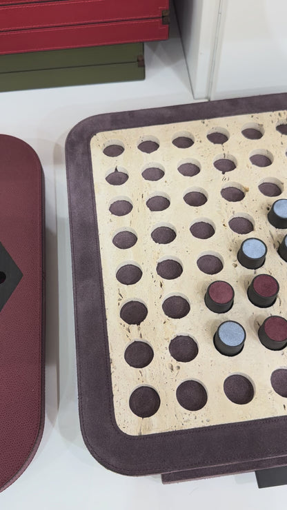 Giobagnara | Delos Othello Game Set Marble: Arabescato white or travertino leather-covered board with metal playing pieces and leather inserts | Game Room | 2Jour Concierge, your luxury lifestyle shop | luxury othello marble, Giobagnara Delos, marble game board, Italian designer game