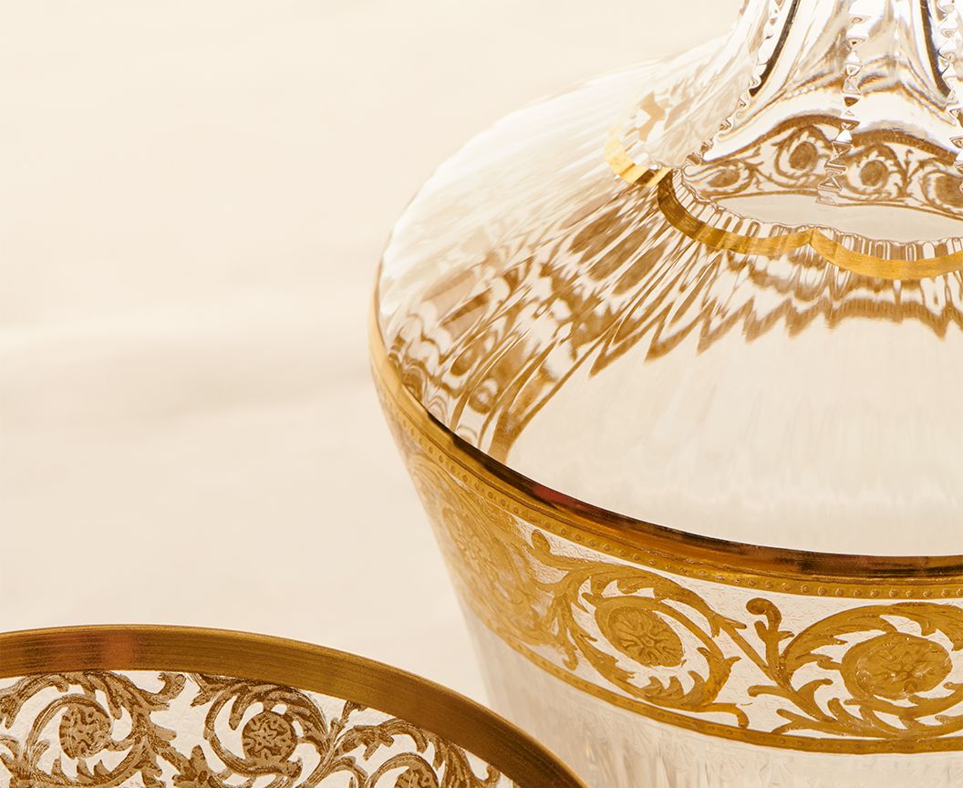 Thistle Wine Carafe by Saint-Louis | Inspired by the Chardon service from 1913 | Features a plant motif engraved frieze decorated in fine gold | Venetian-style stripes, bevel cuts, and 24-carat gold or platinum decoration | Collection: Thistle | Color: Clear | Design: Timeless | Tableware and Wine Carafes | 2Jour Concierge, your luxury lifestyle shop